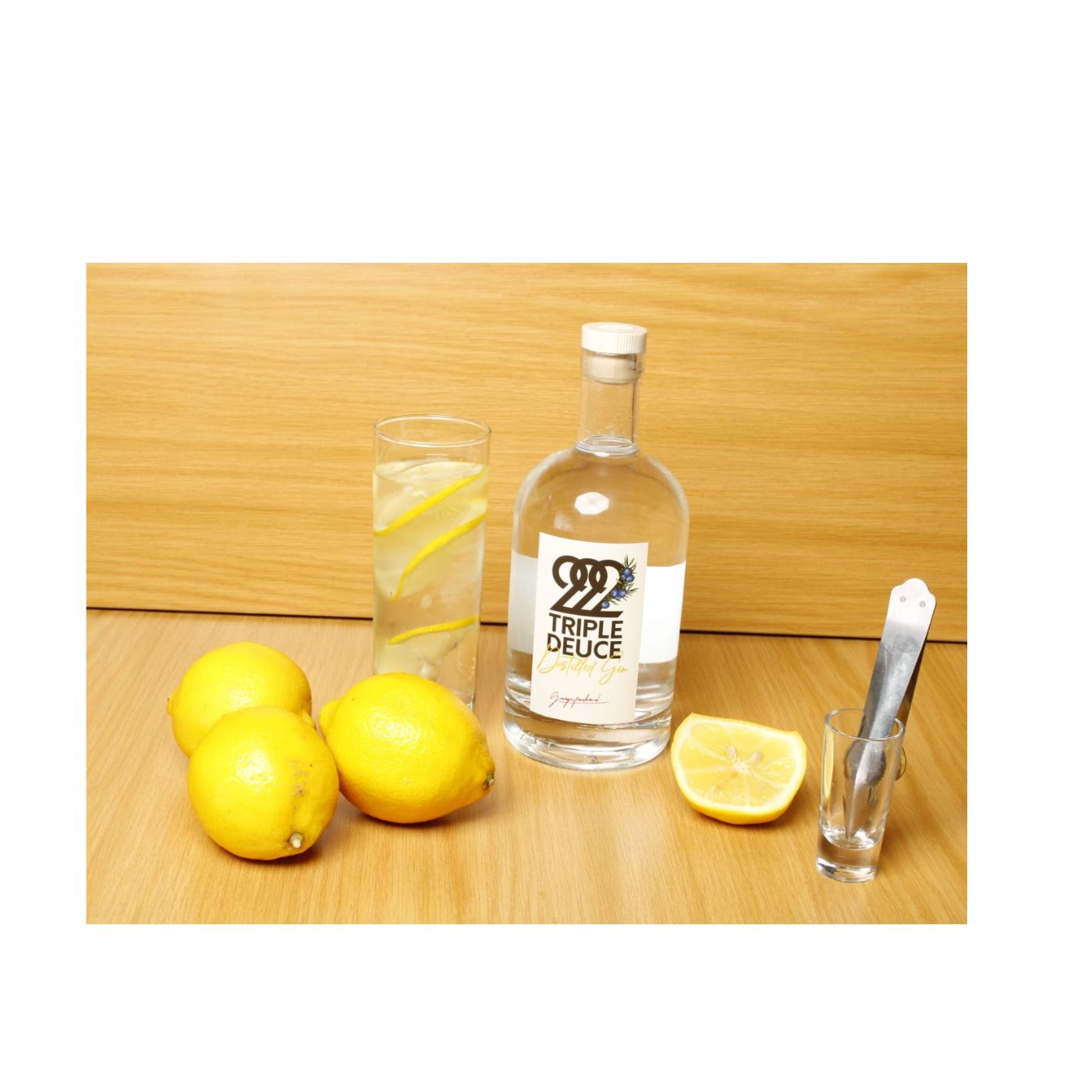 222 Triple Deuce Gin bottle with lemons and a sleek design.