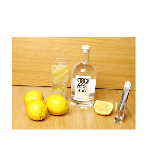 222 Triple Deuce Gin bottle with lemons and a sleek design.
